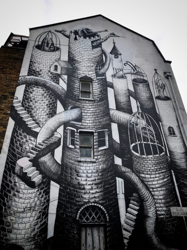 Side of building with large artwork by Phlegm